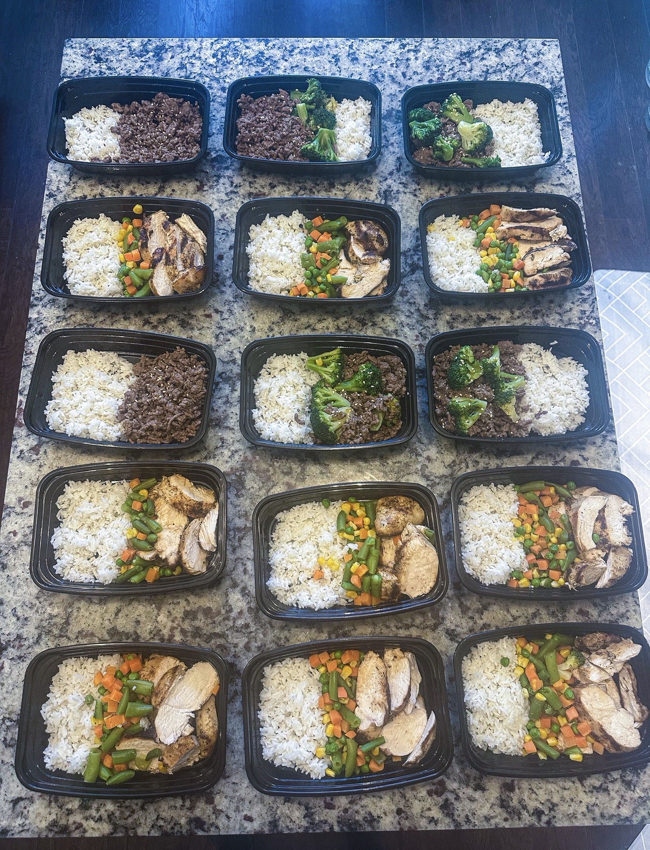 A full batch of healthy high-protein meal prep containers with rice, vegetables, chicken, and beef made at The O Life Center in Little Elm, TX
