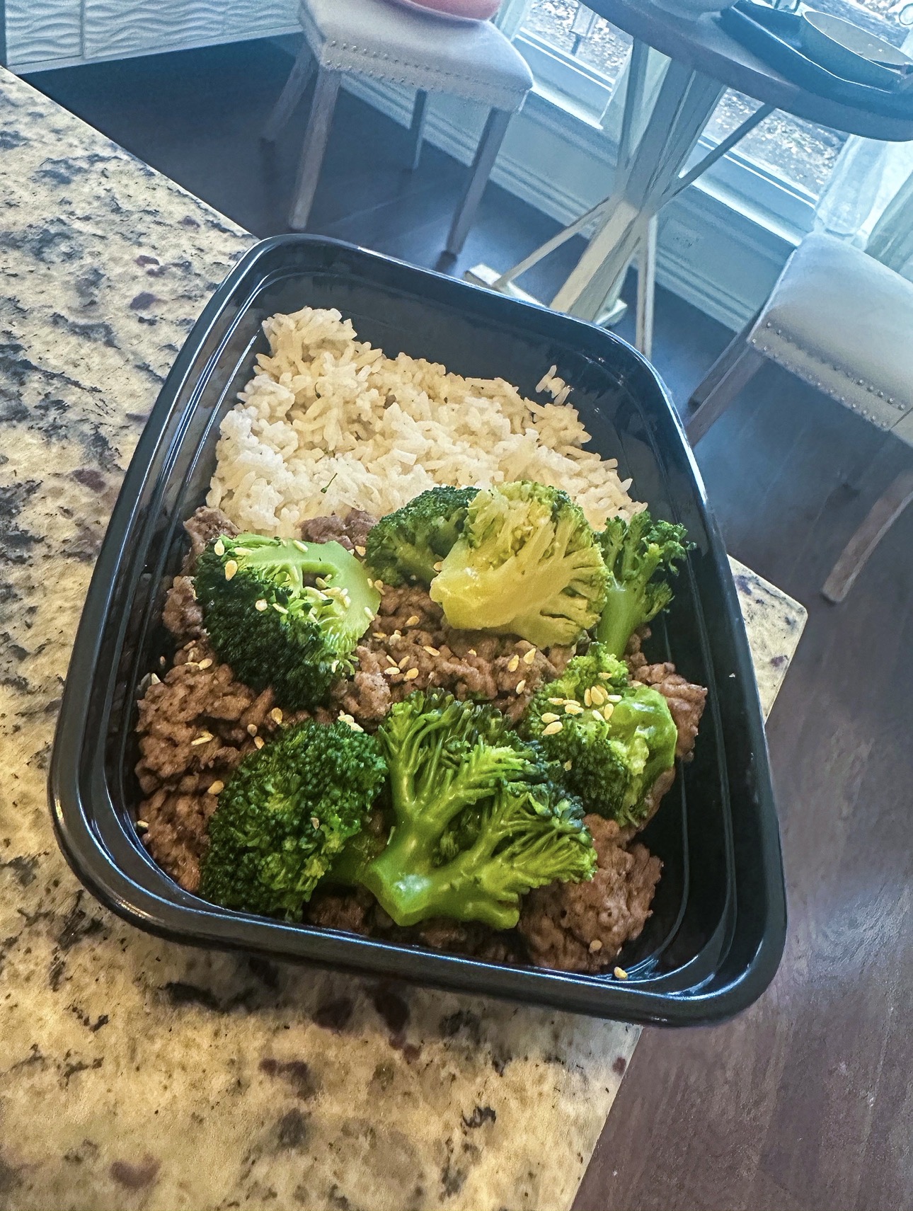 Seasoned ground beef with broccoli and rice in a fitness meal prep container from The O Life Center