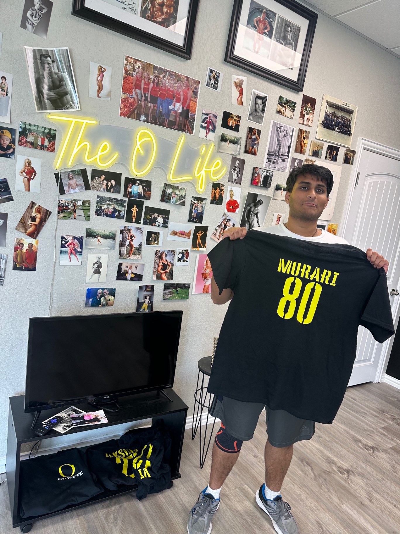 Murari holding his O Life athlete jersey, number 80